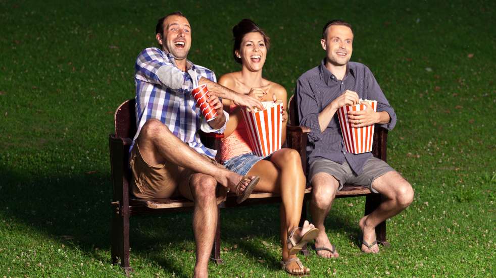 Man and two women enjoying outdoor movie